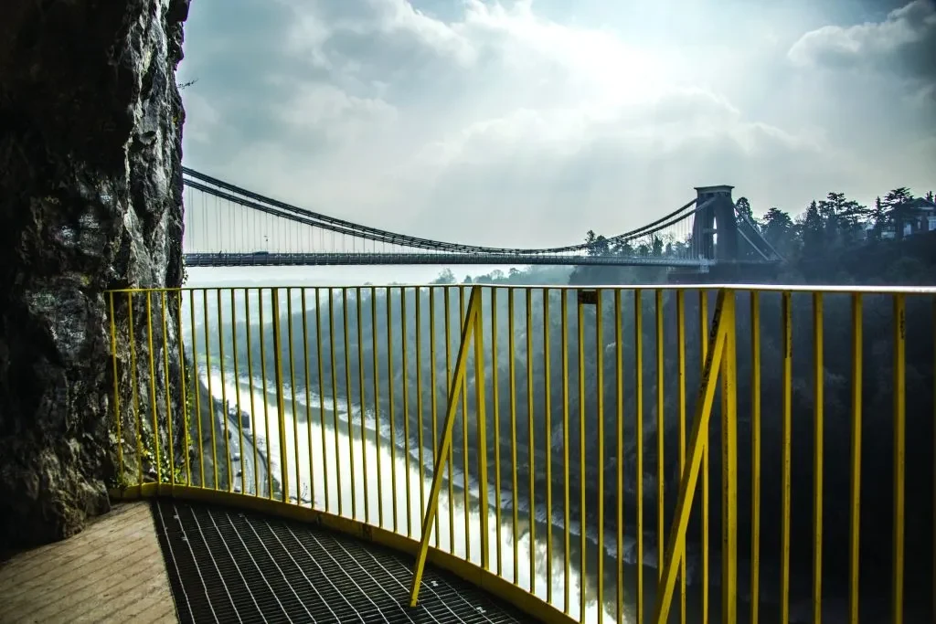 Clifton Suspension Bridge seen from the Giant’s Cave viewing platform behind yellow railings