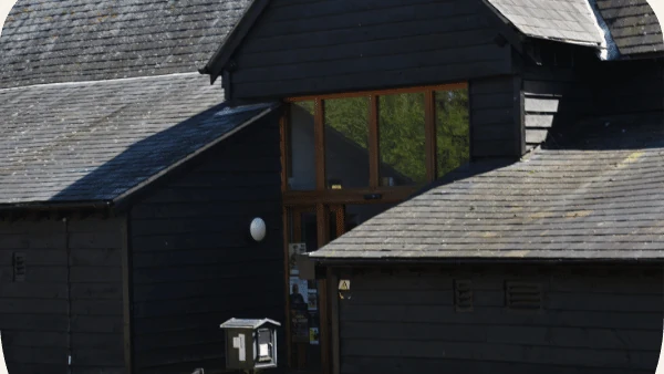 Black timber barn and glazed entrance at Hanger Farm Arts Centre in Totton
