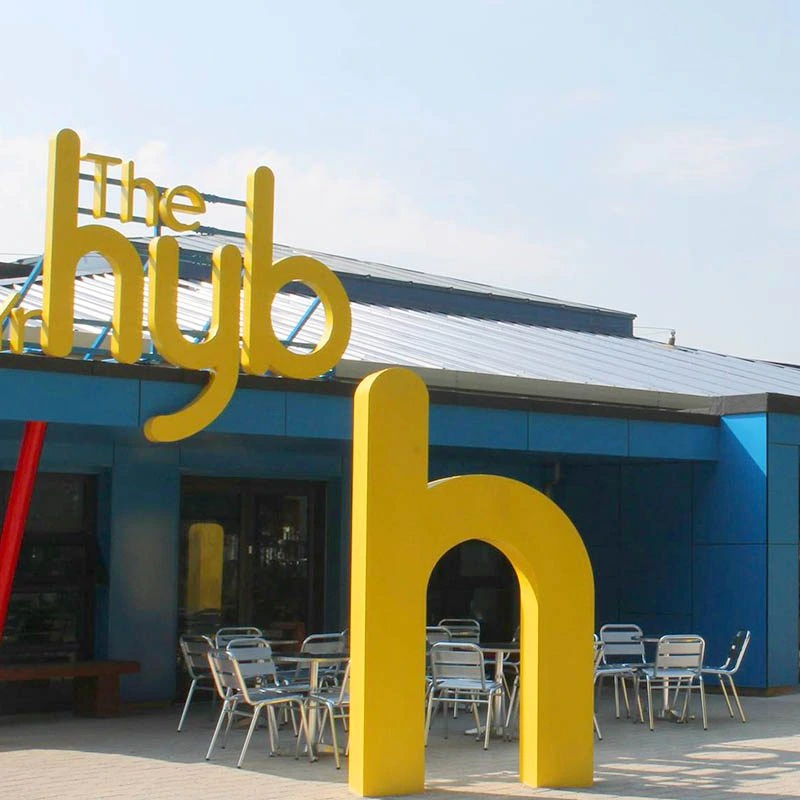 The blue exterior and yellow hub lettering at Ely and Caerau Hub in Cardiff