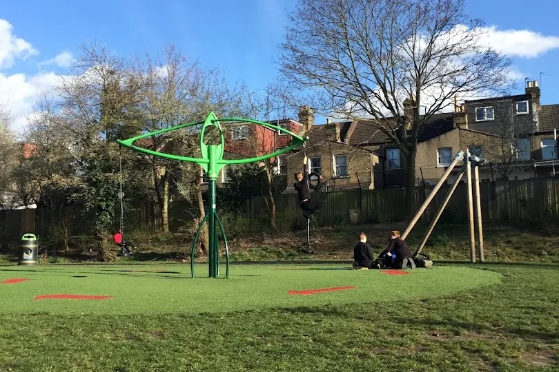 Play equipment beyond the grass at Sidmouth Park