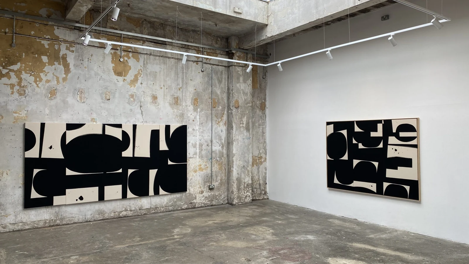 Copeland Gallery interior with exposed roof beams and black-and-white abstract paintings