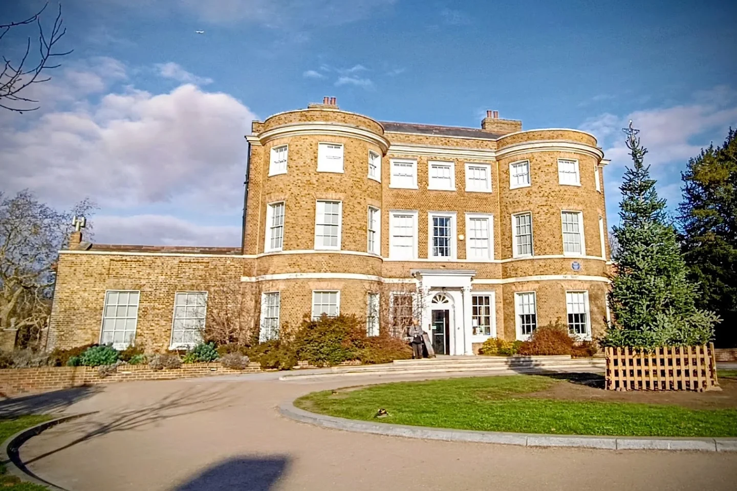 William Morris Gallery's brick exterior beside the curved path in Lloyd Park