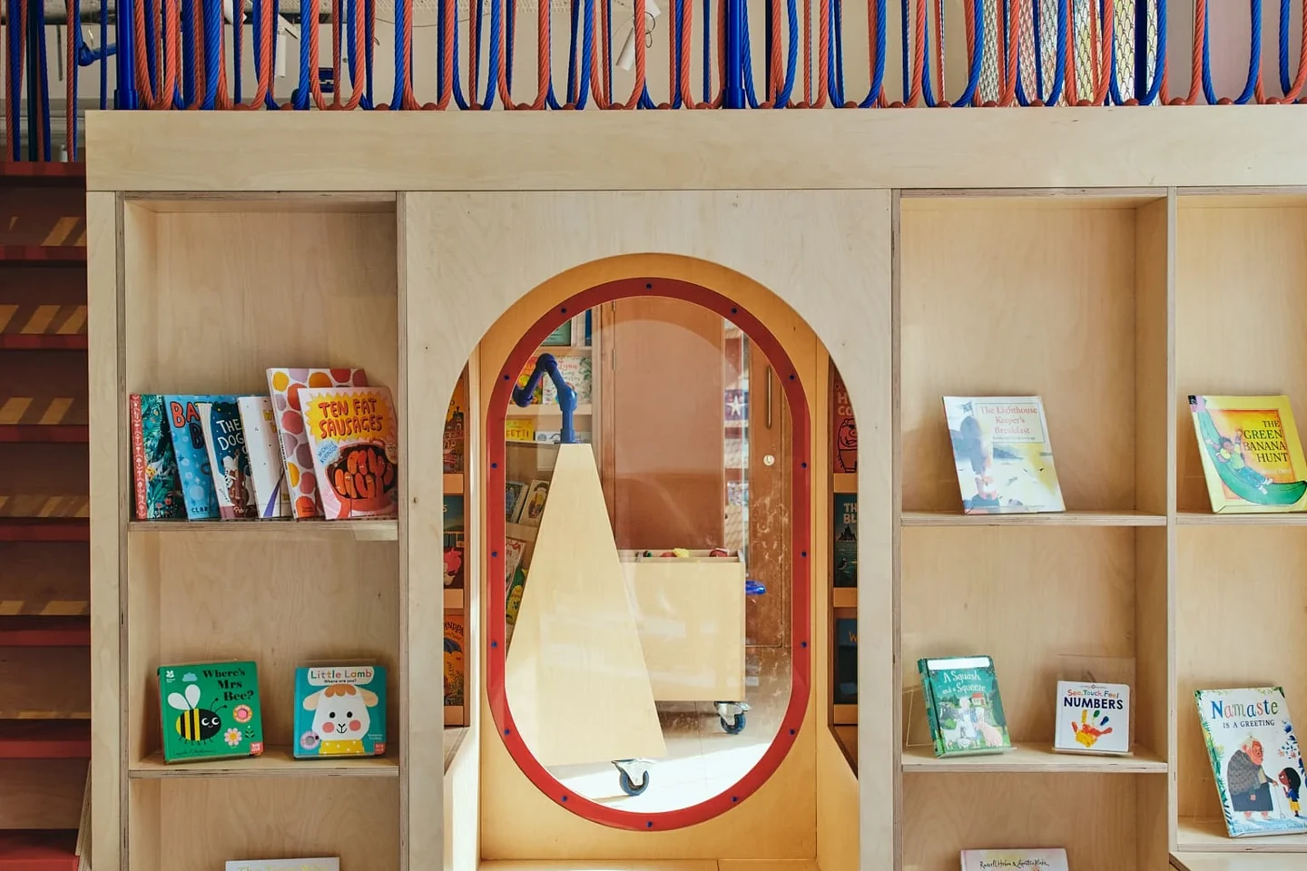 Bookshelves and a mirror inside Discover Children's Story Centre