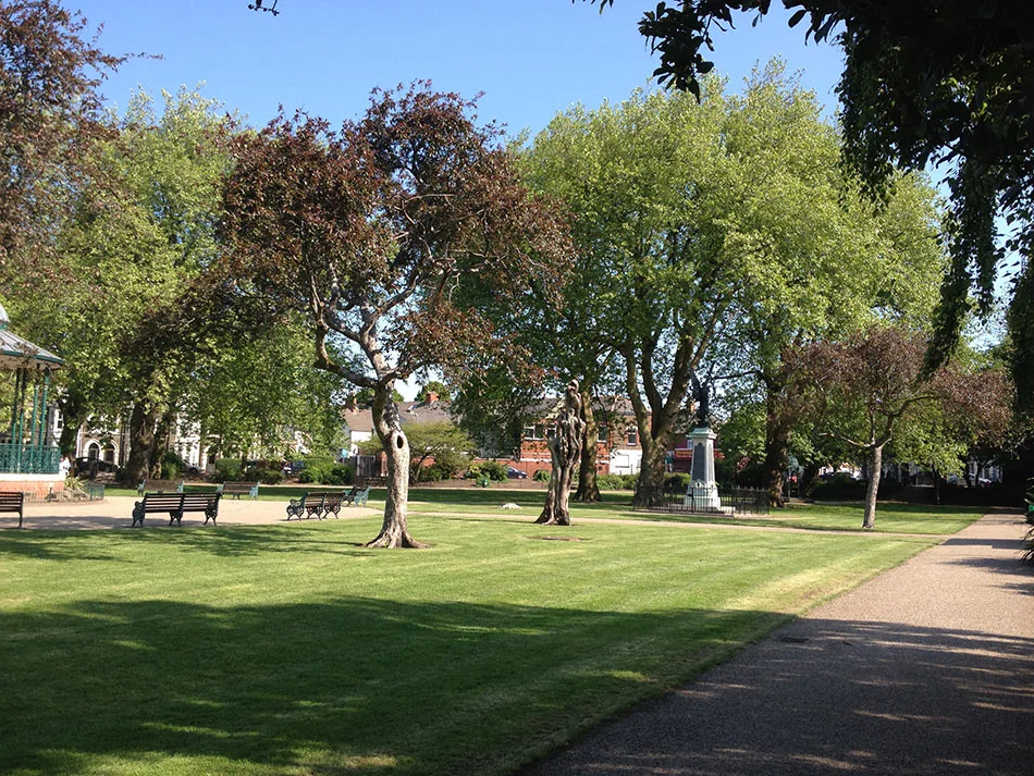 Lawns, paths, benches and trees in Grange Gardens, Grangetown, Cardiff.