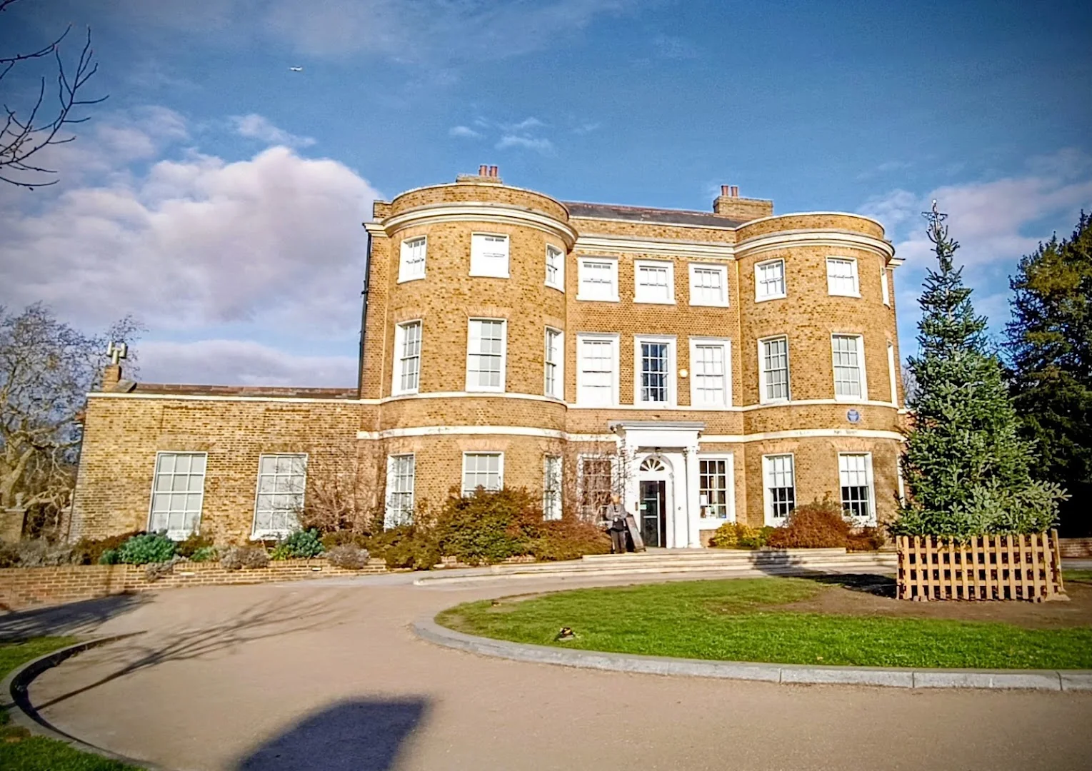 William Morris Gallery's brick exterior beside the curved path in Lloyd Park