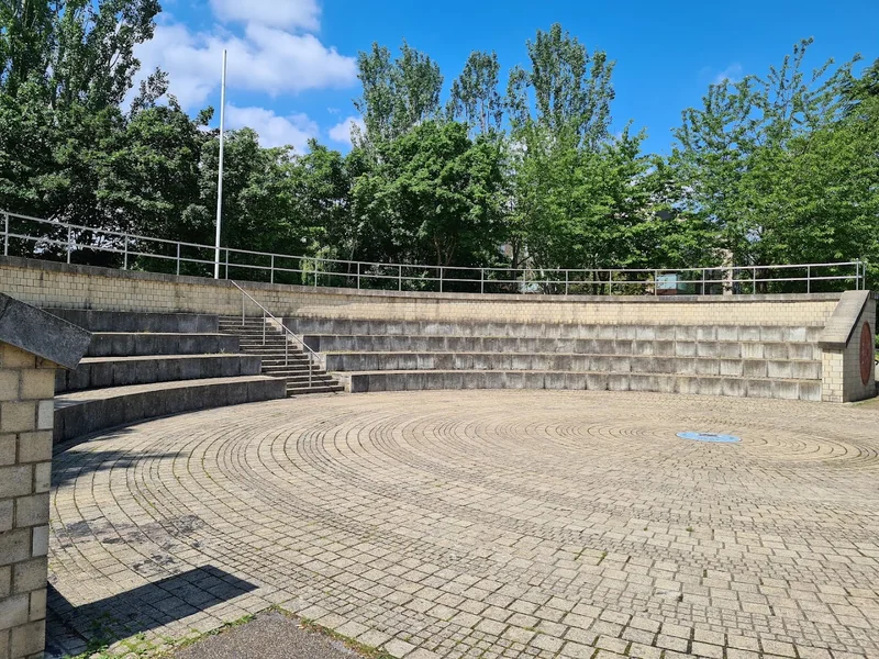 Circular paved amphitheatre and stone seating at Langthorne Park