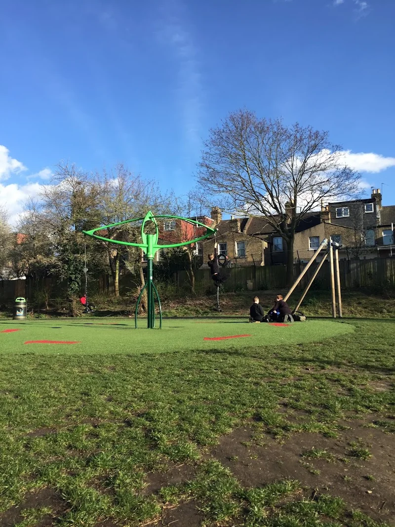 Play equipment beyond the grass at Sidmouth Park