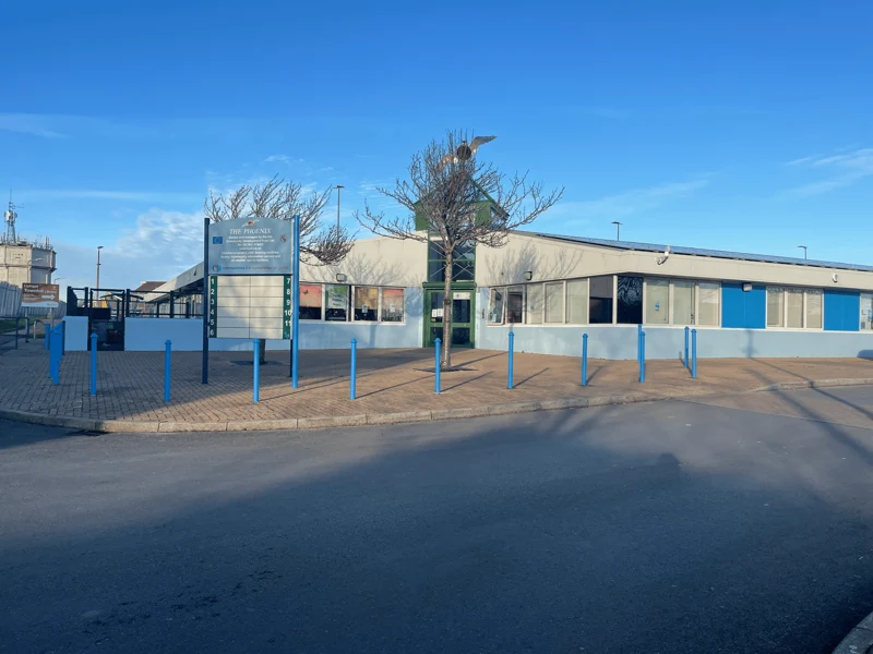 The Phoenix Centre frontage in Townhill, Swansea, with blue panels and bollards beside the entrance