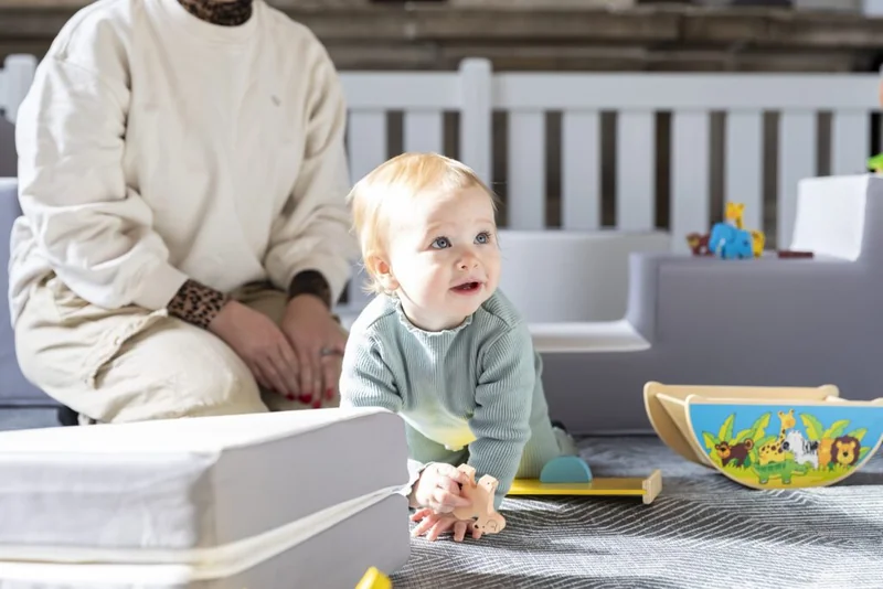 A toddler exploring soft play blocks in St Mary’s church play area.