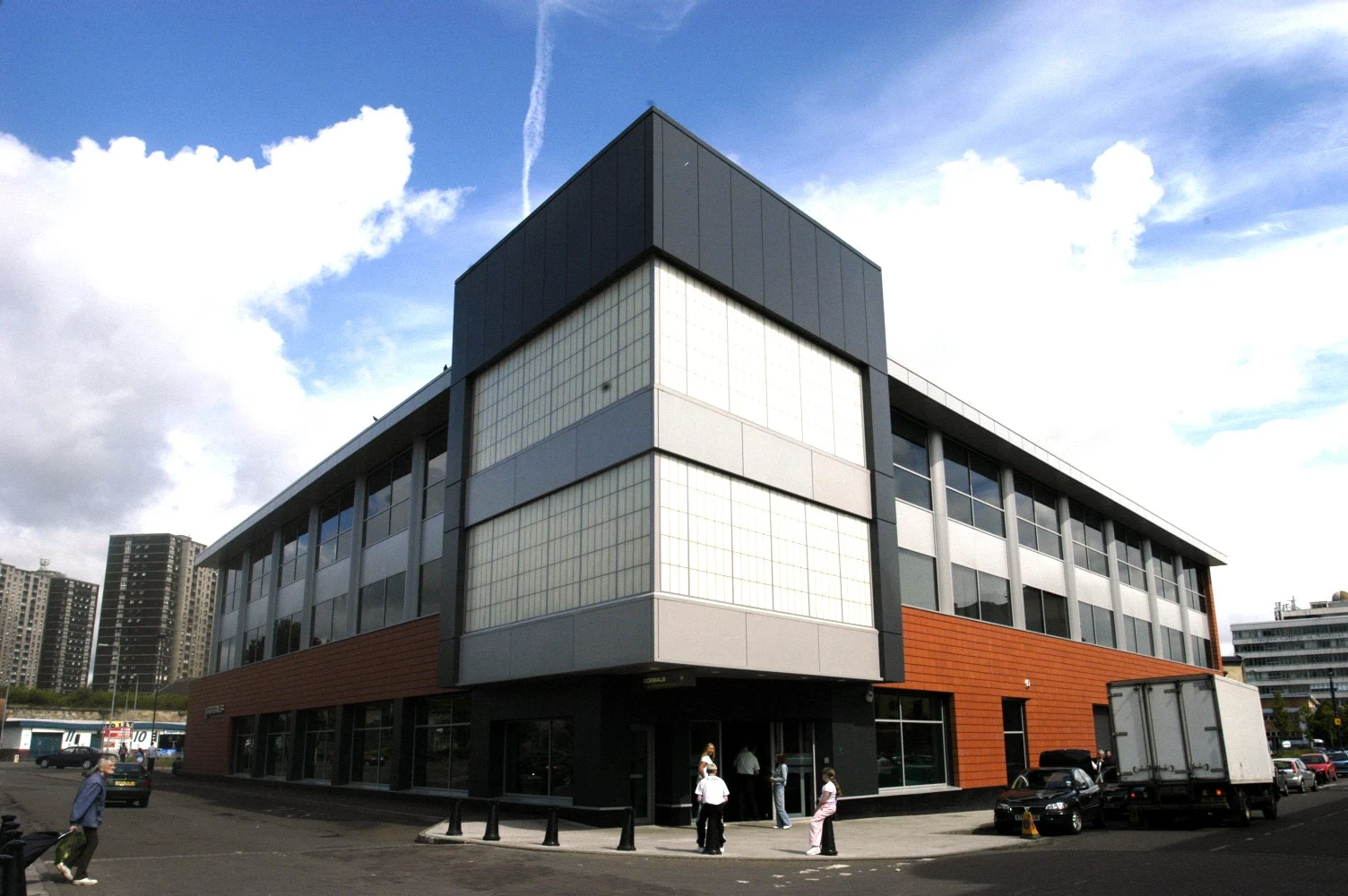 Gorbals Library’s angular glazed corner above the entrance, with orange lower cladding