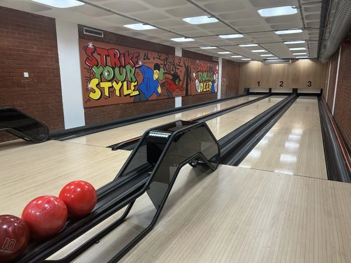 Three bowling lanes and red bowling balls at Brixton Recreation Centre