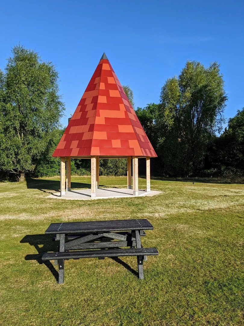 Red-roofed shelter and picnic bench at Ridgeway Park